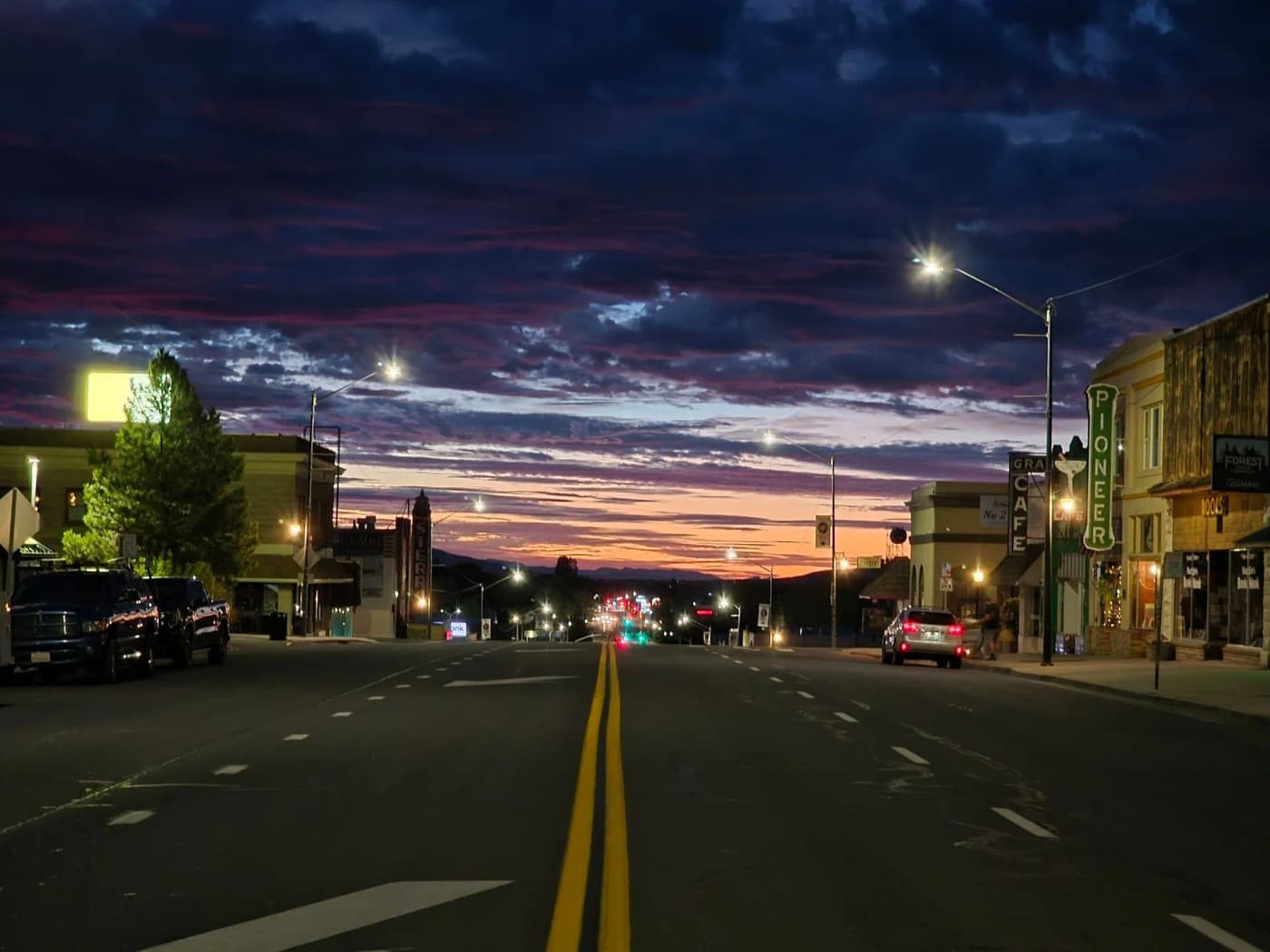 Downtown Susanville street at dusk under a dramatic sunset sky